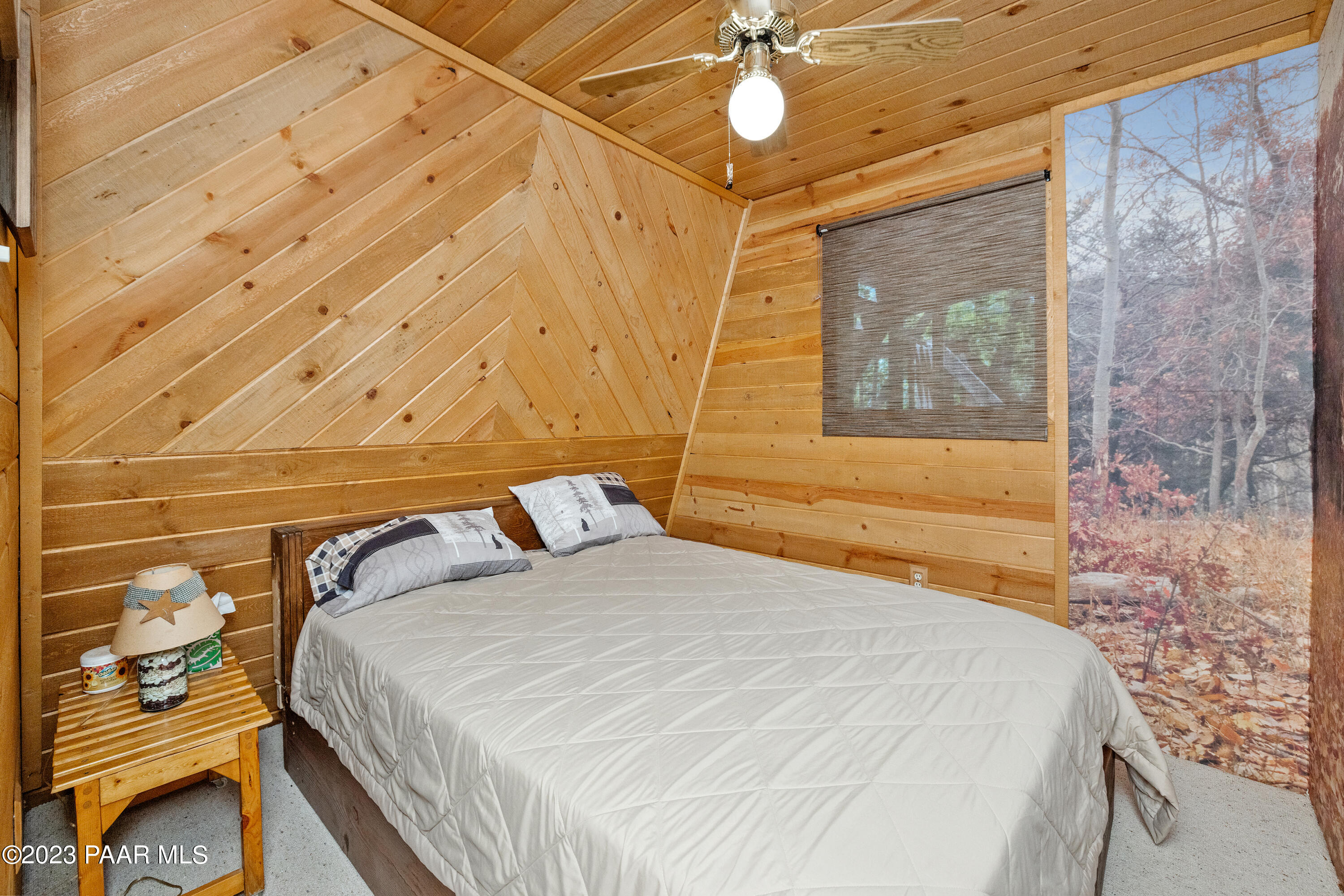 8434 Mountain View Road Mayer, AZ 86333 - Photo 22 of 33 a bedroom with a bed and a chandelier