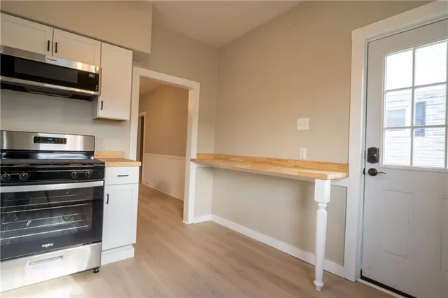a kitchen with a stove and a microwave