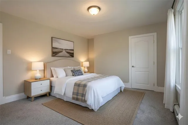 a bedroom with a bed and a night stand