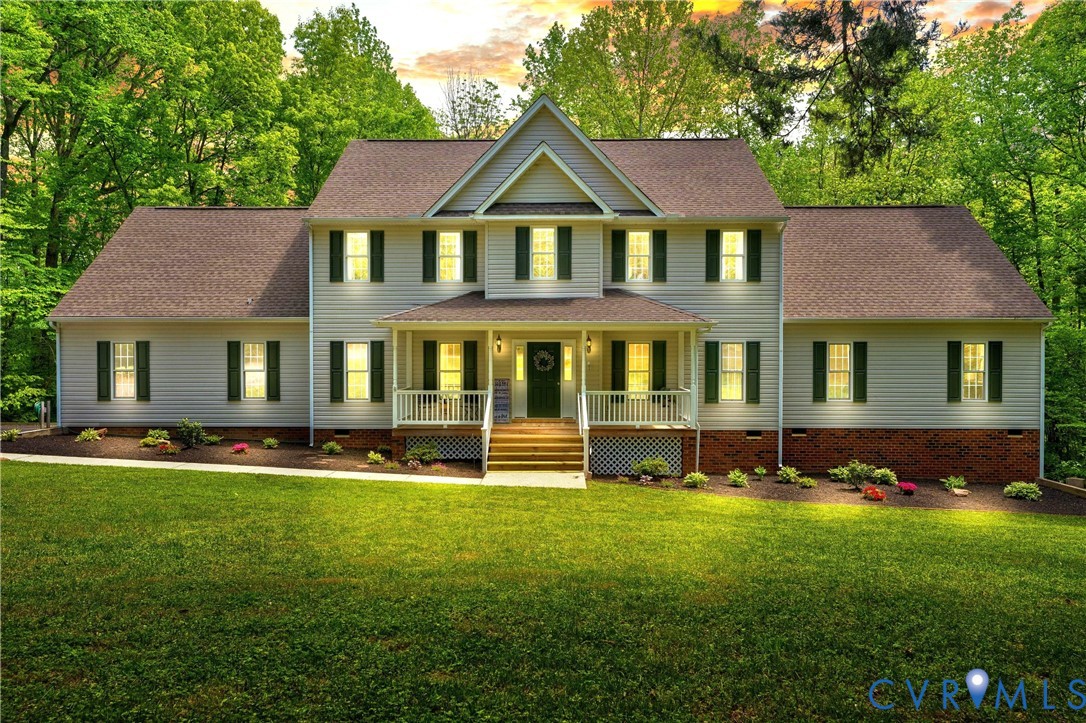 16148 Buckfast Place Beaverdam, VA 23015 - Photo 1 of 48 a front view of a house with a yard table and chairs