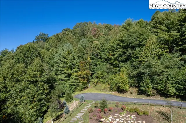 a view of a yard with wooden fence