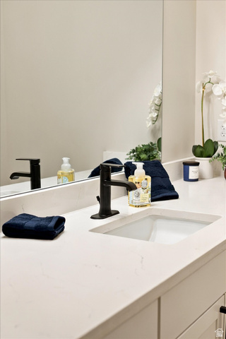 754 West 400 North Mapleton, UT 84664 - Photo 51 of 86 Integrated rectangular sink with a matte black faucet, set within a light-toned countertop.