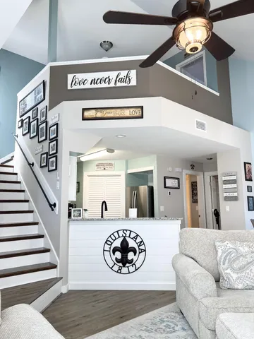 a view of a livingroom with furniture and staircase