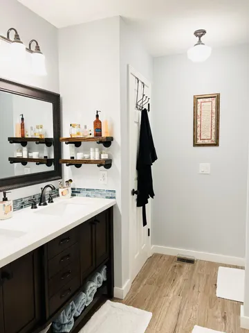 a bathroom with a sink vanity and a mirror