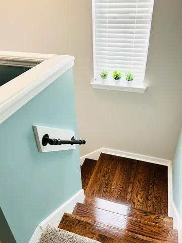 a view of entryway and hall with wooden floor