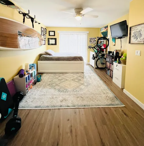 a room with gym equipment and a flat screen tv