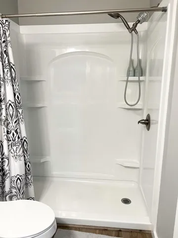 a bathroom with a toilet and shower