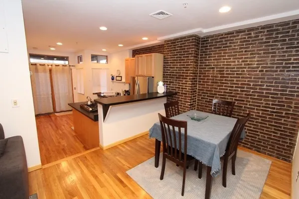 a dining room with furniture and wooden floor
