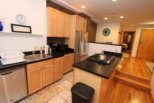 a kitchen with stainless steel appliances a stove a sink and a microwave