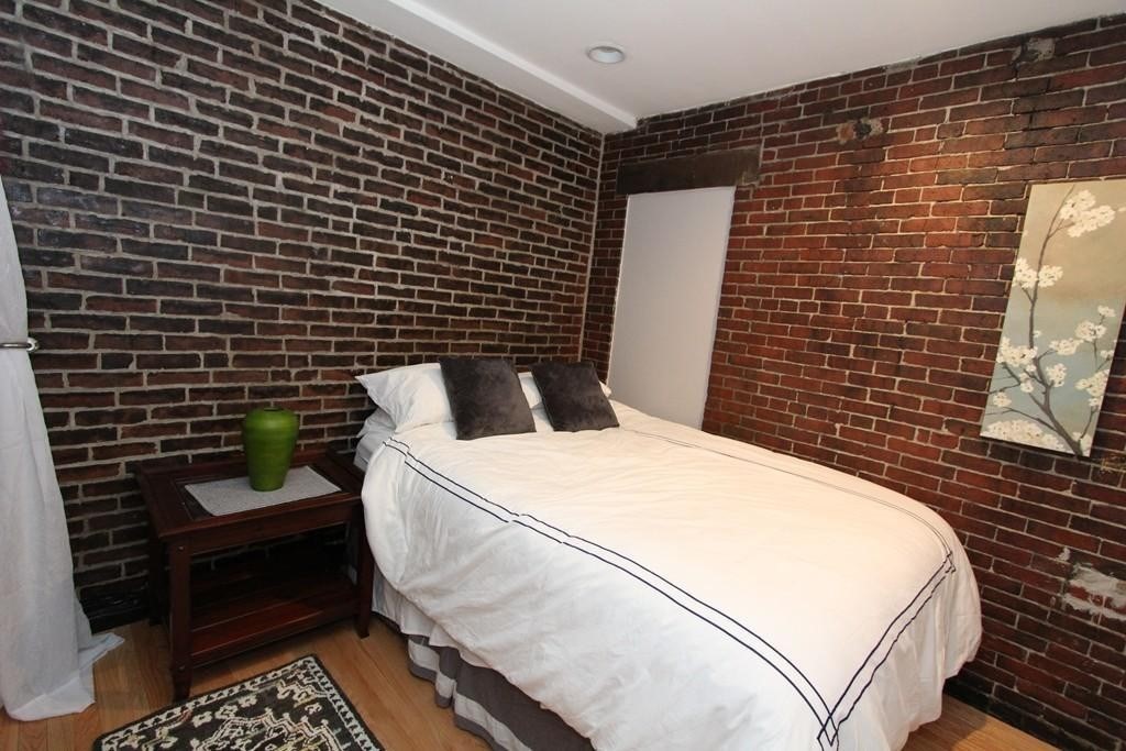 49-51 Temple Place, Unit 2R Boston, MA 02111 - Photo 6 of 7 a bathroom with a toilet and a shower