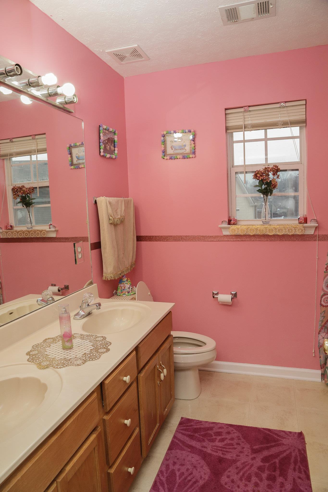 5301 Ridgefalls Way Antioch, TN 37013 - Photo 23 of 30 a bathroom with a sink a vanity and toilet