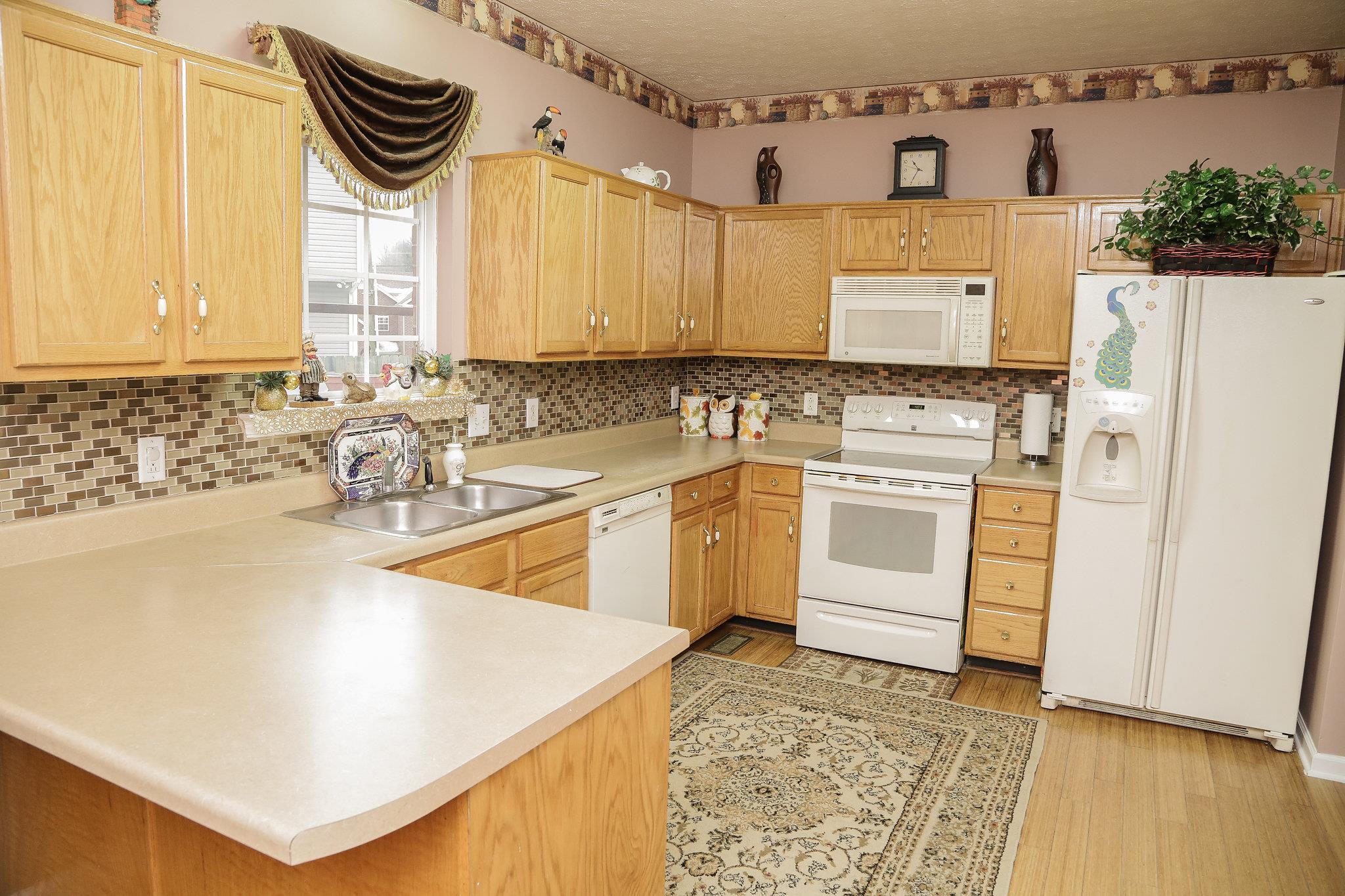 5301 Ridgefalls Way Antioch, TN 37013 - Photo 8 of 30 a kitchen with a sink a stove and cabinets
