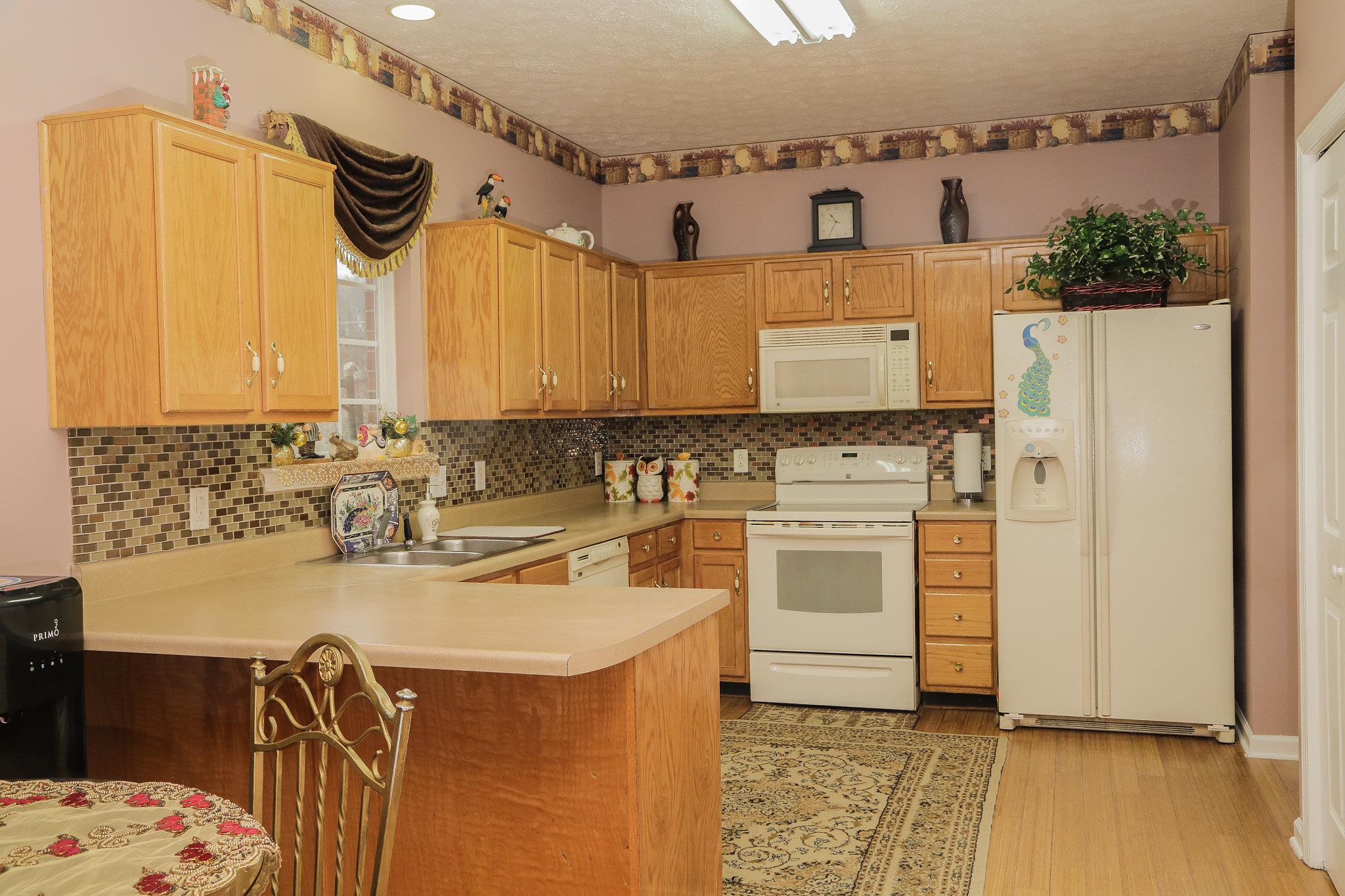 5301 Ridgefalls Way Antioch, TN 37013 - Photo 9 of 30 a kitchen with a sink stove and refrigerator