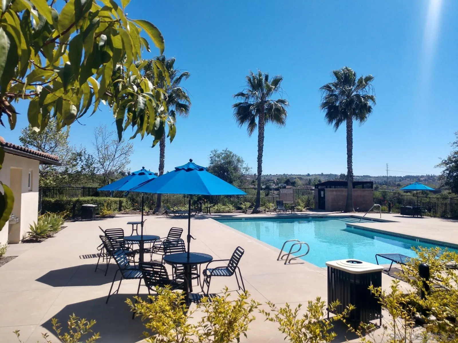 5074 Cascade Way, Unit 101 Oceanside, CA 92057 - Photo 1 of 12 a view of a swimming pool with a table and chairs