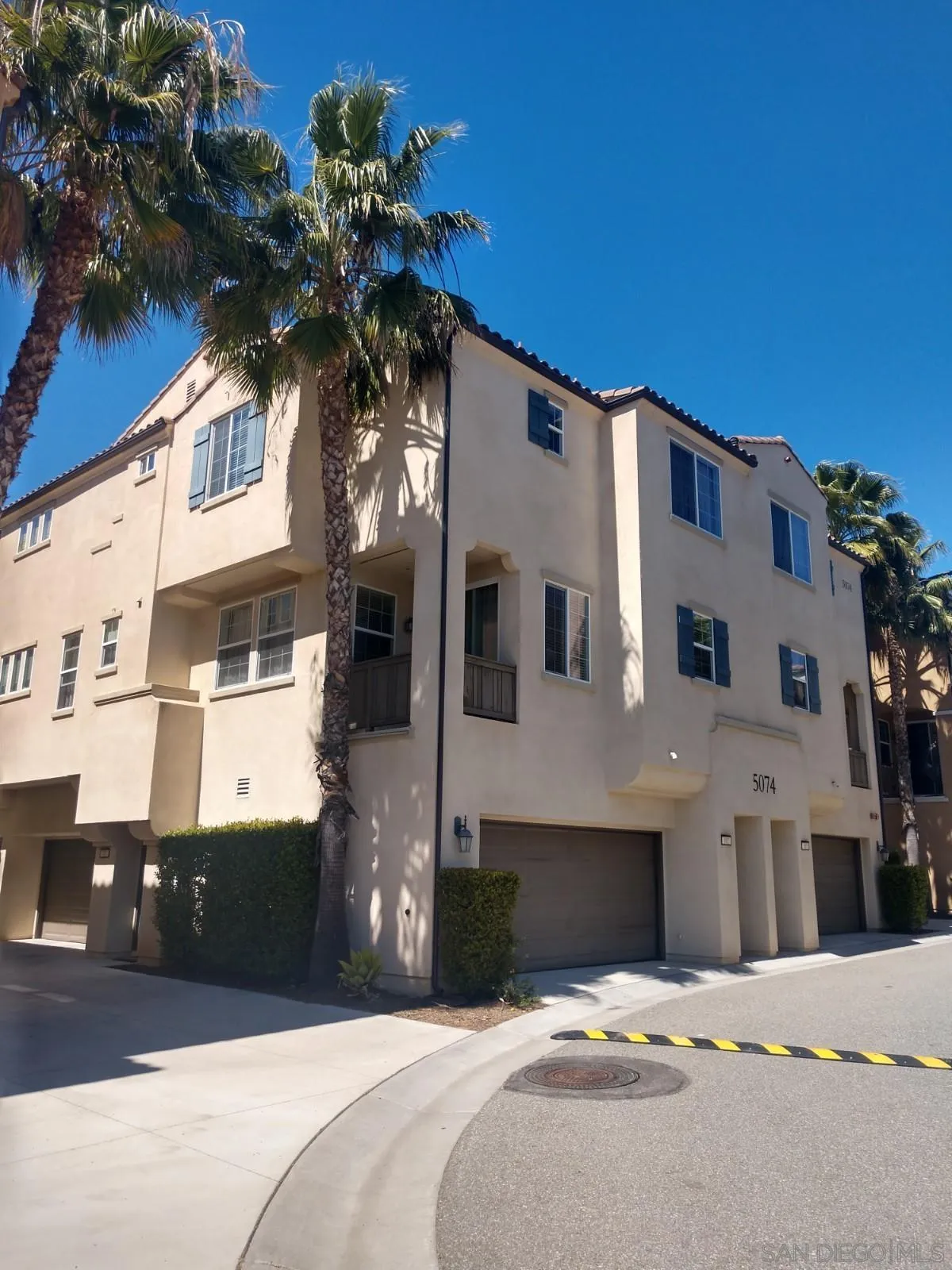 5074 Cascade Way, Unit 101 Oceanside, CA 92057 - Photo 3 of 12 a front view of a house with a yard