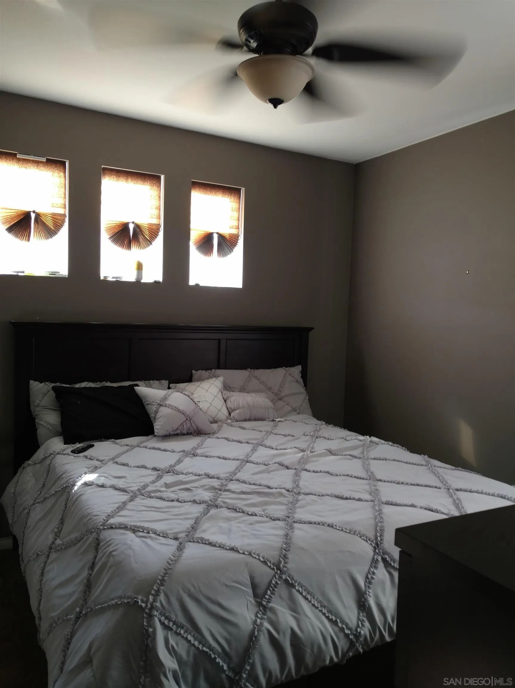5074 Cascade Way, Unit 101 Oceanside, CA 92057 - Photo 9 of 12 a bedroom with a bed and window