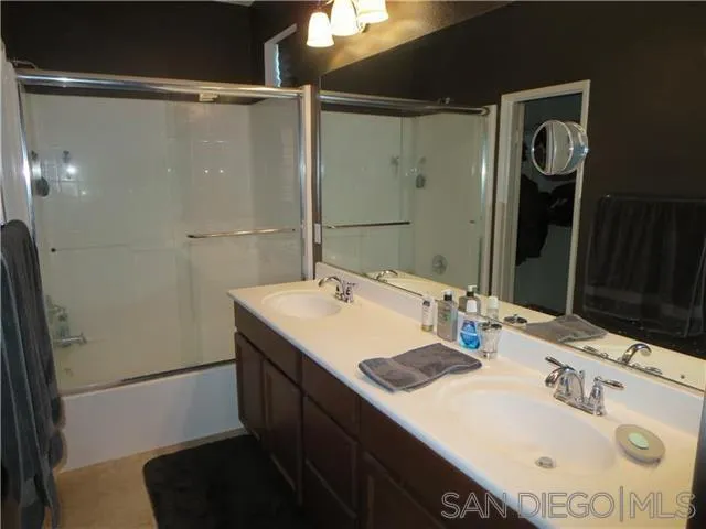 5074 Cascade Way, Unit 101 Oceanside, CA 92057 - Photo 10 of 12 a bathroom with a sink and a mirror