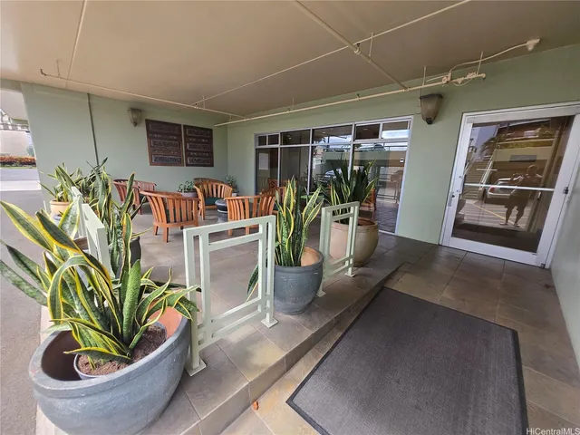 a dining room filled with furniture and potted plant