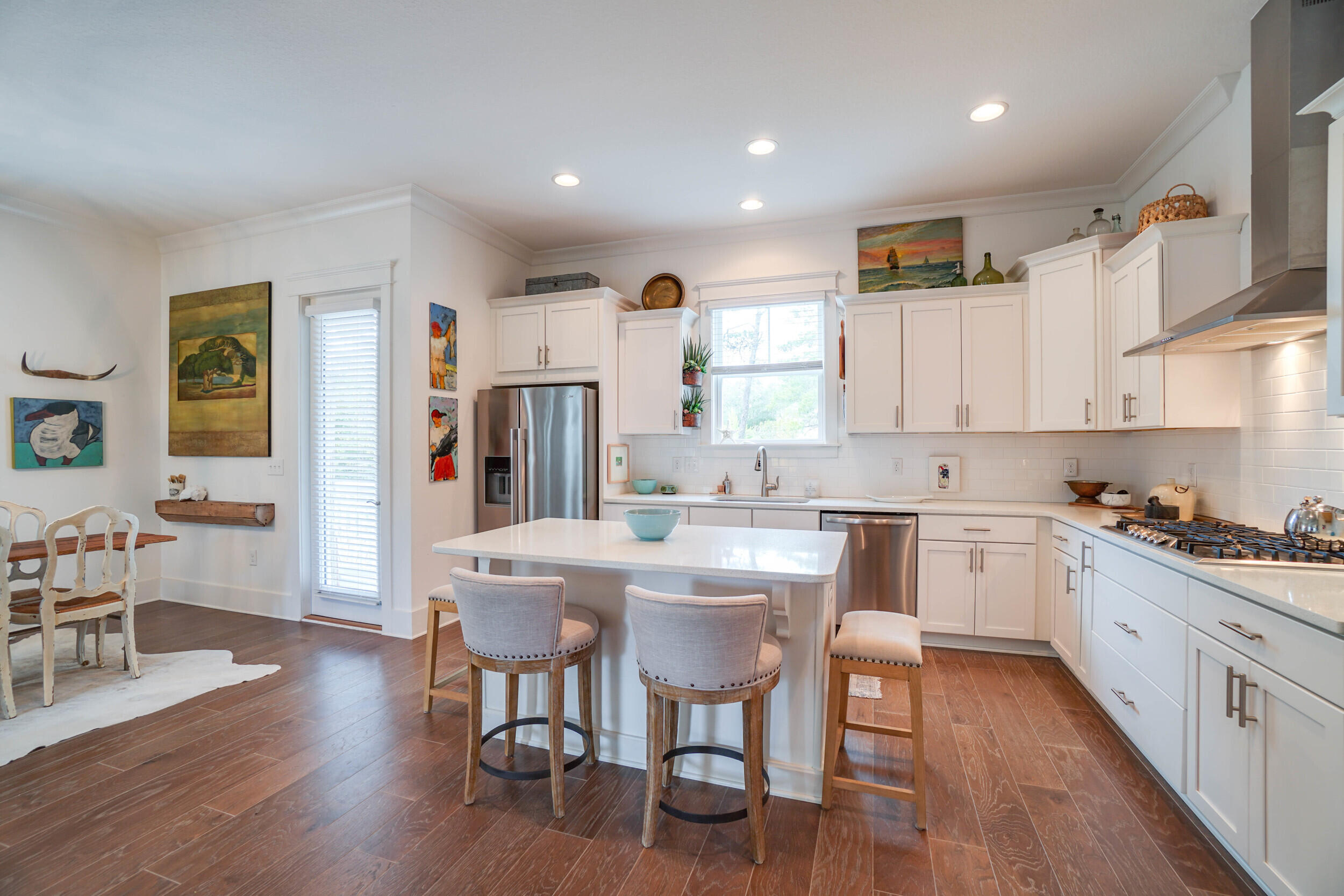 364 Grande Pointe Circle Inlet Beach, FL 32461 - Photo 8 of 26 a kitchen with stainless steel appliances granite countertop a dining table chairs refrigerator sink and cabinets
