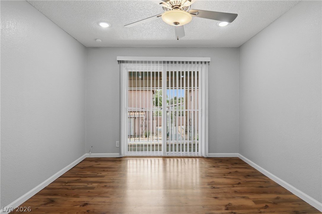 2274 East Desert Inn Road Las Vegas, NV 89169 - Photo 30 of 41 Rich wood flooring and bright patio doors illuminate this adaptable interior space.