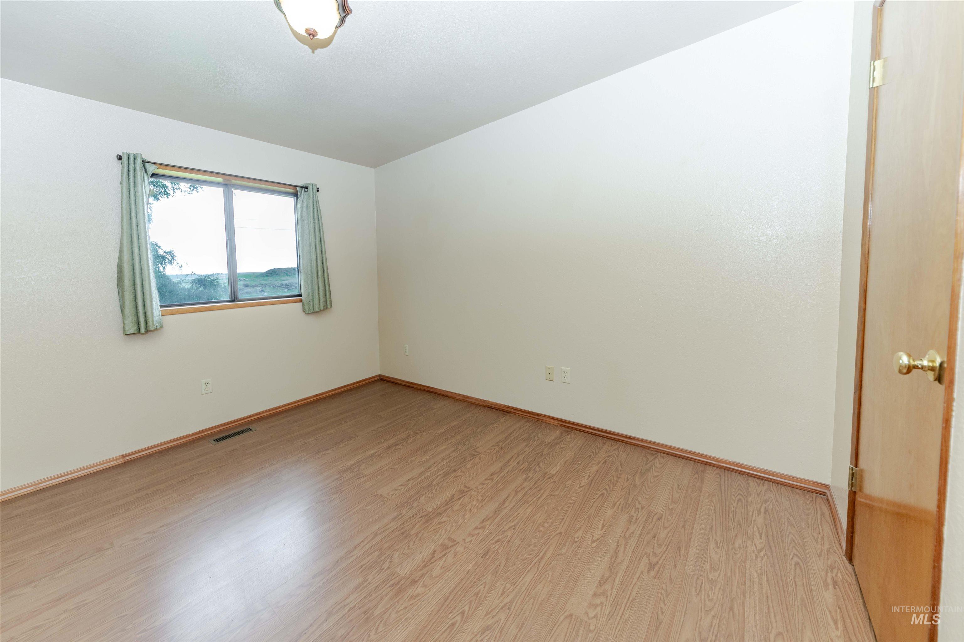 1316 29th Street Lewiston, ID 83501 - Photo 15 of 31 Bedroom with light wood finished floors and baseboards
