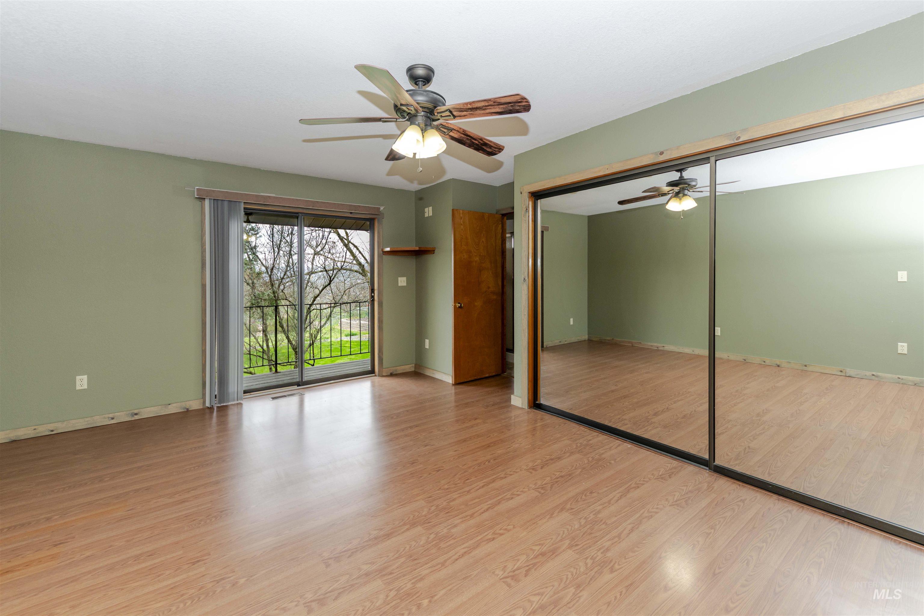 1316 29th Street Lewiston, ID 83501 - Photo 17 of 31 Primary bedroom featuring access to outside, light wood finished floors, a closet, and ceiling fan