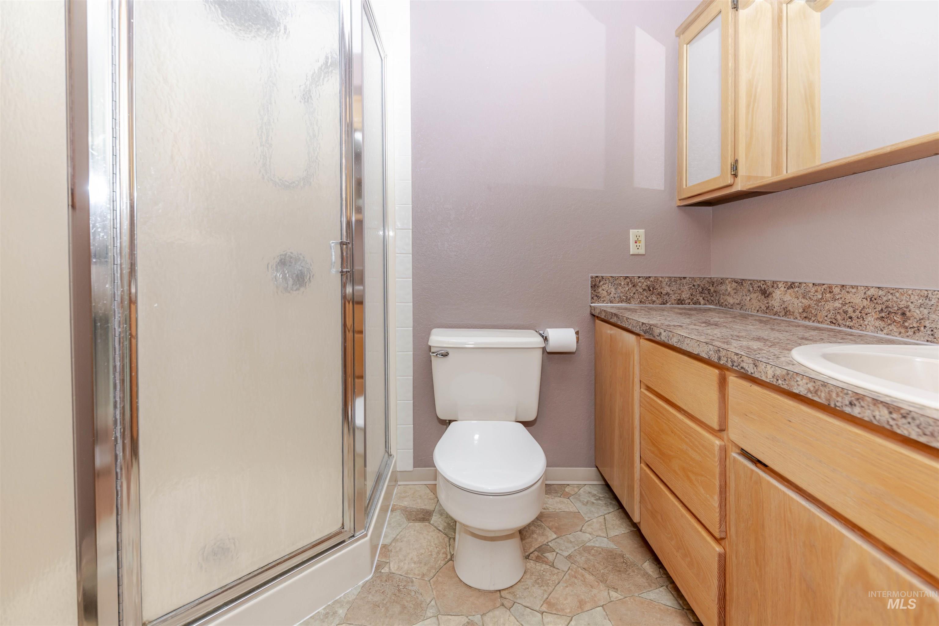 1316 29th Street Lewiston, ID 83501 - Photo 18 of 31 Primary bathroom featuring a shower stall and vanity