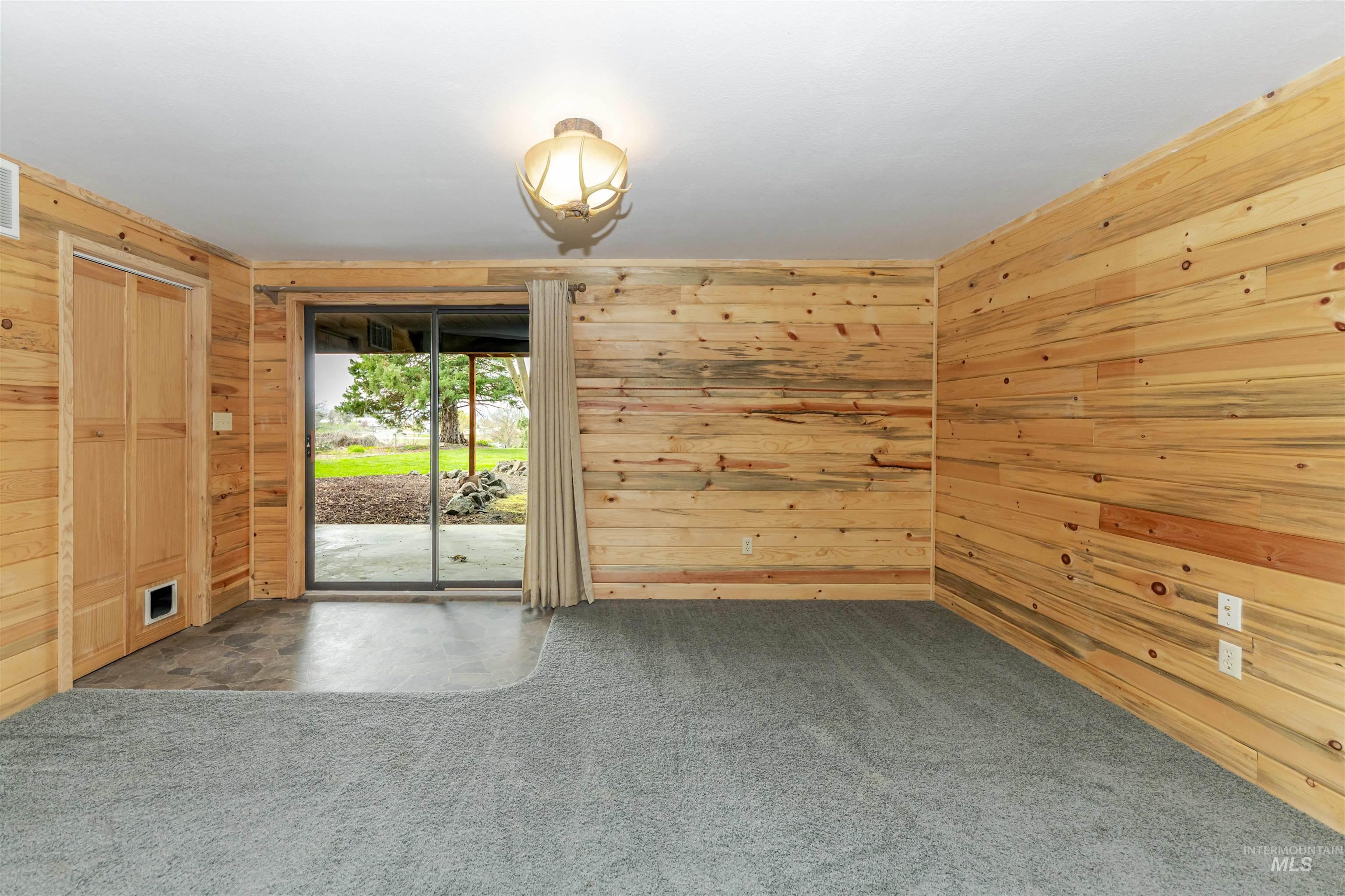 1316 29th Street Lewiston, ID 83501 - Photo 20 of 31 Carpeted family room with access to backyard featuring wooden walls
