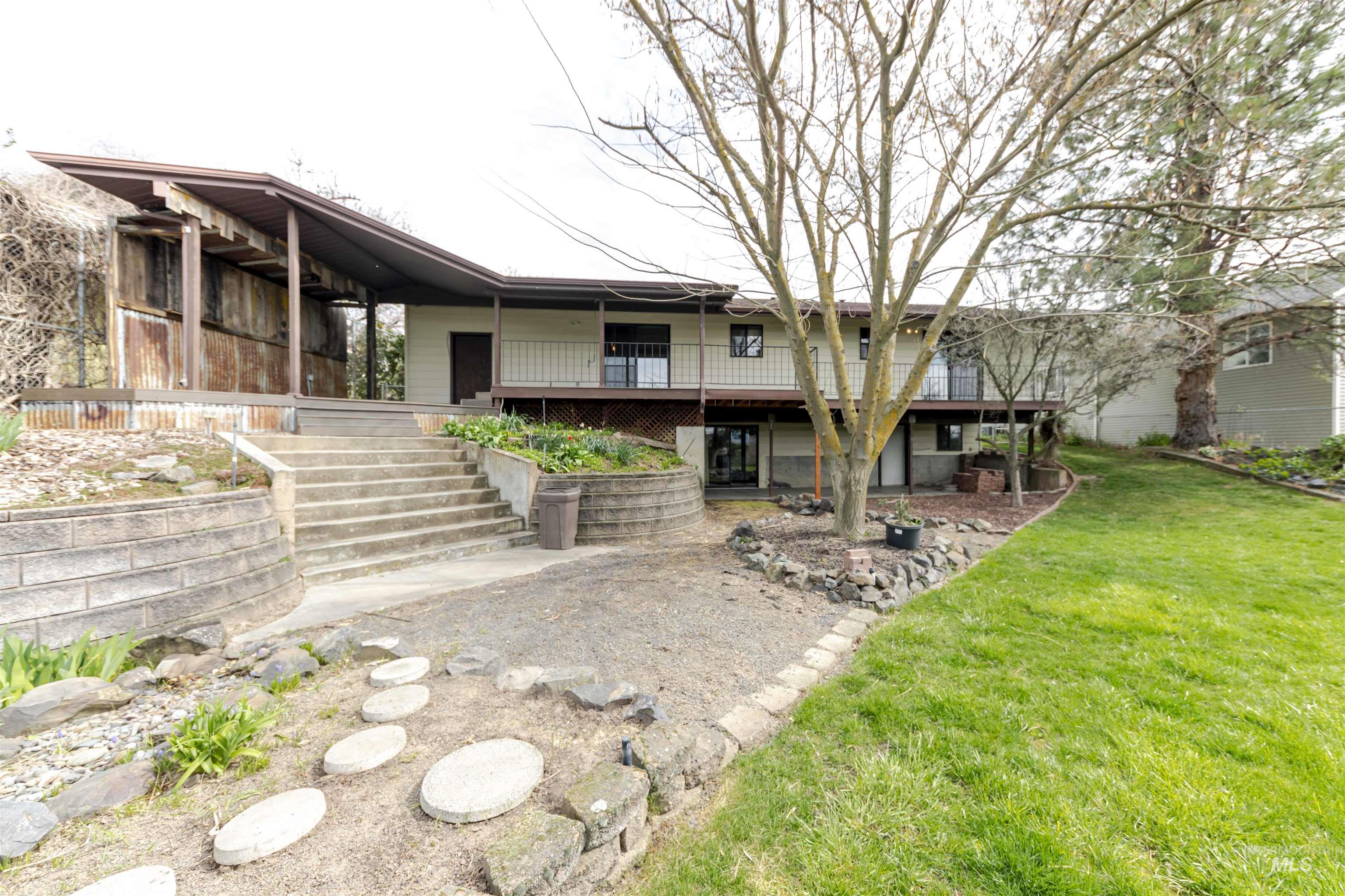 1316 29th Street Lewiston, ID 83501 - Photo 24 of 31 Rear view of property featuring a lawn and a wooden deck