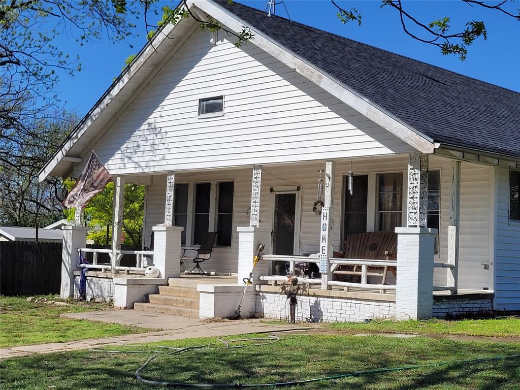 a view of a house with backyard porch and sitting area