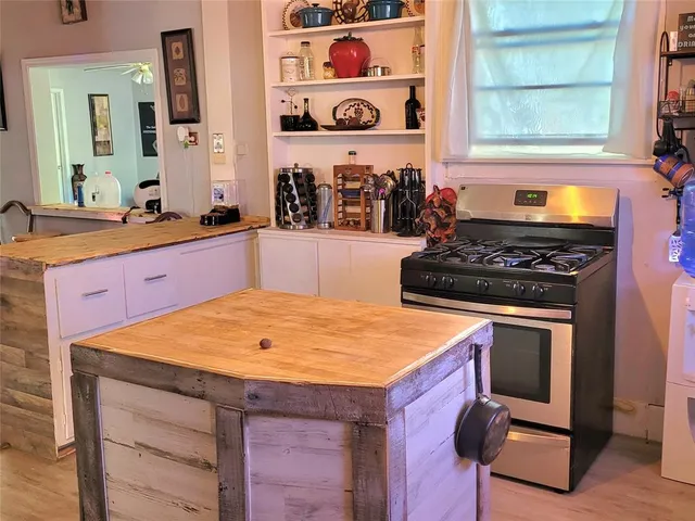 a kitchen with stainless steel appliances granite countertop a stove and a sink