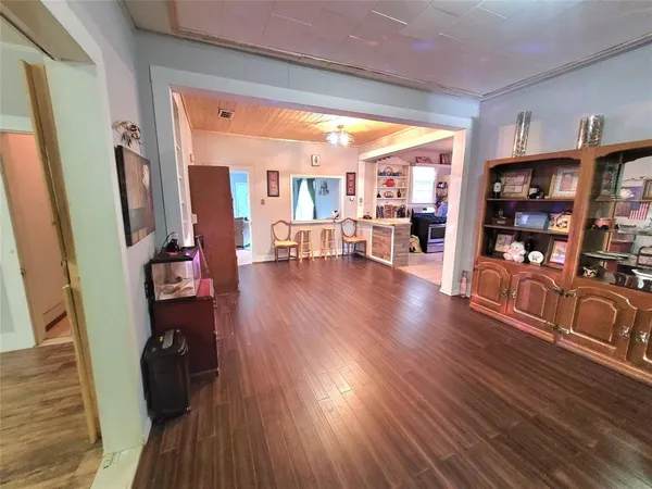 a view of a living room with furniture and wooden floor