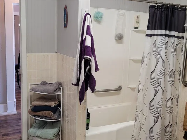 a bathroom with a bathtub and a shower