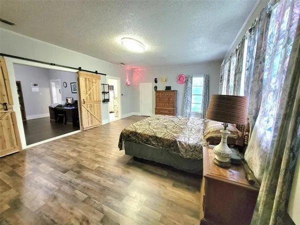 a bedroom with a bed and a television