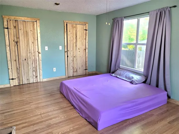a bedroom with a bed and a window