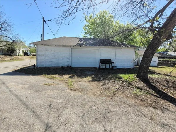 a view of a house with a tree in the background