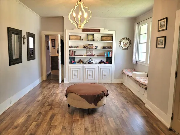 a living room with furniture and a chandelier
