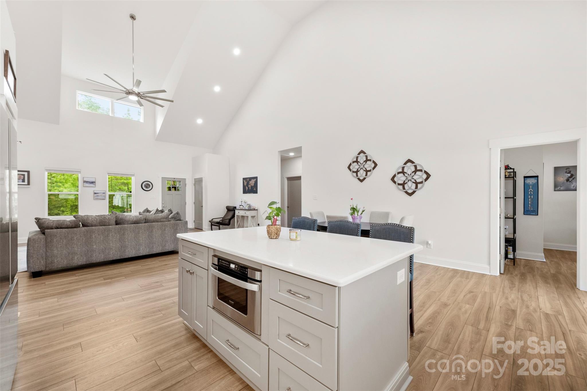7683 Sarah Drive Denver, NC 28037 - Photo 11 of 25 a view of a kitchen counter space a stove and wooden floor