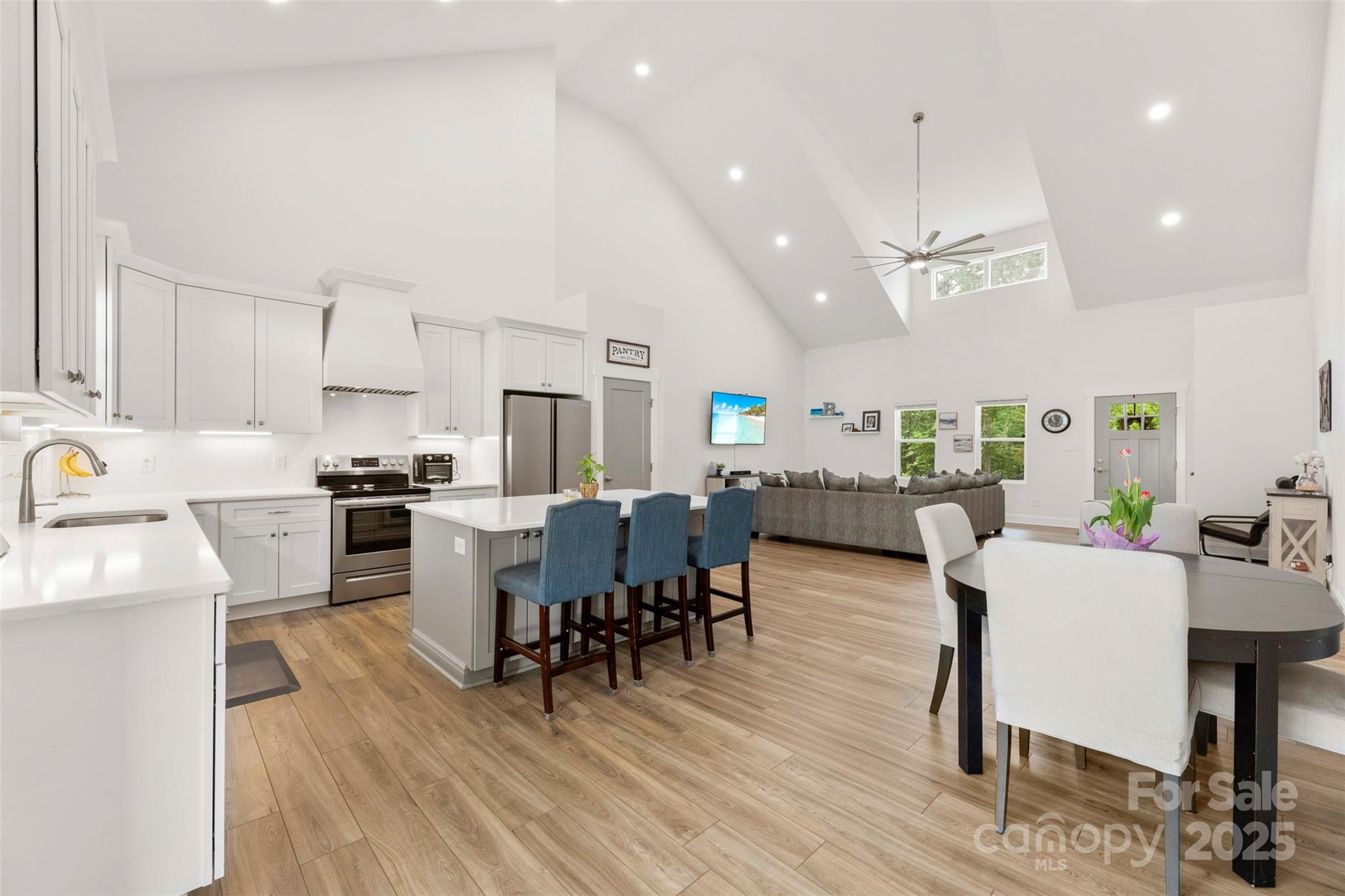 7683 Sarah Drive Denver, NC 28037 - Photo 12 of 25 a kitchen with counter space dining table and chairs