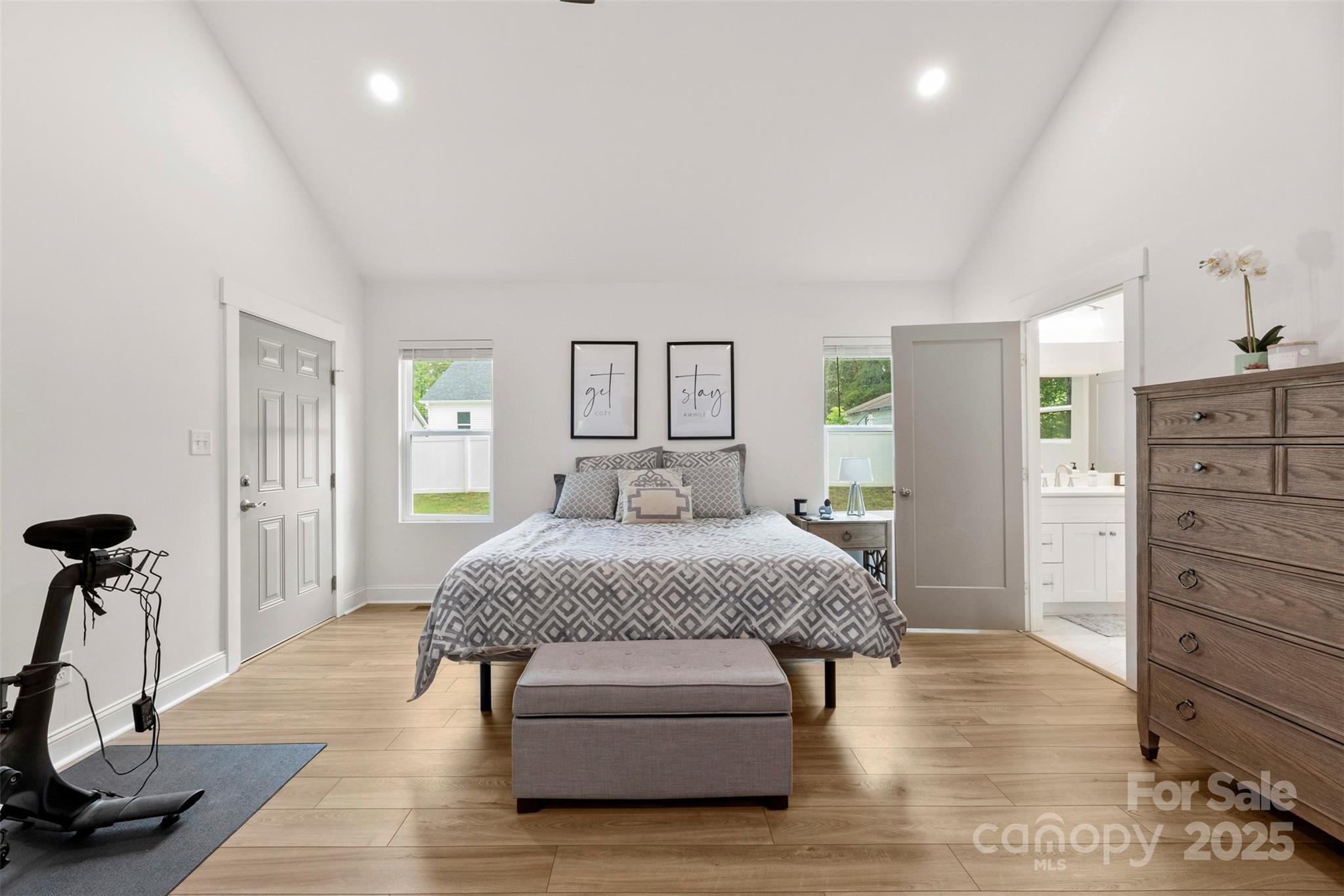 7683 Sarah Drive Denver, NC 28037 - Photo 18 of 25 a spacious bedroom with a bed and a table