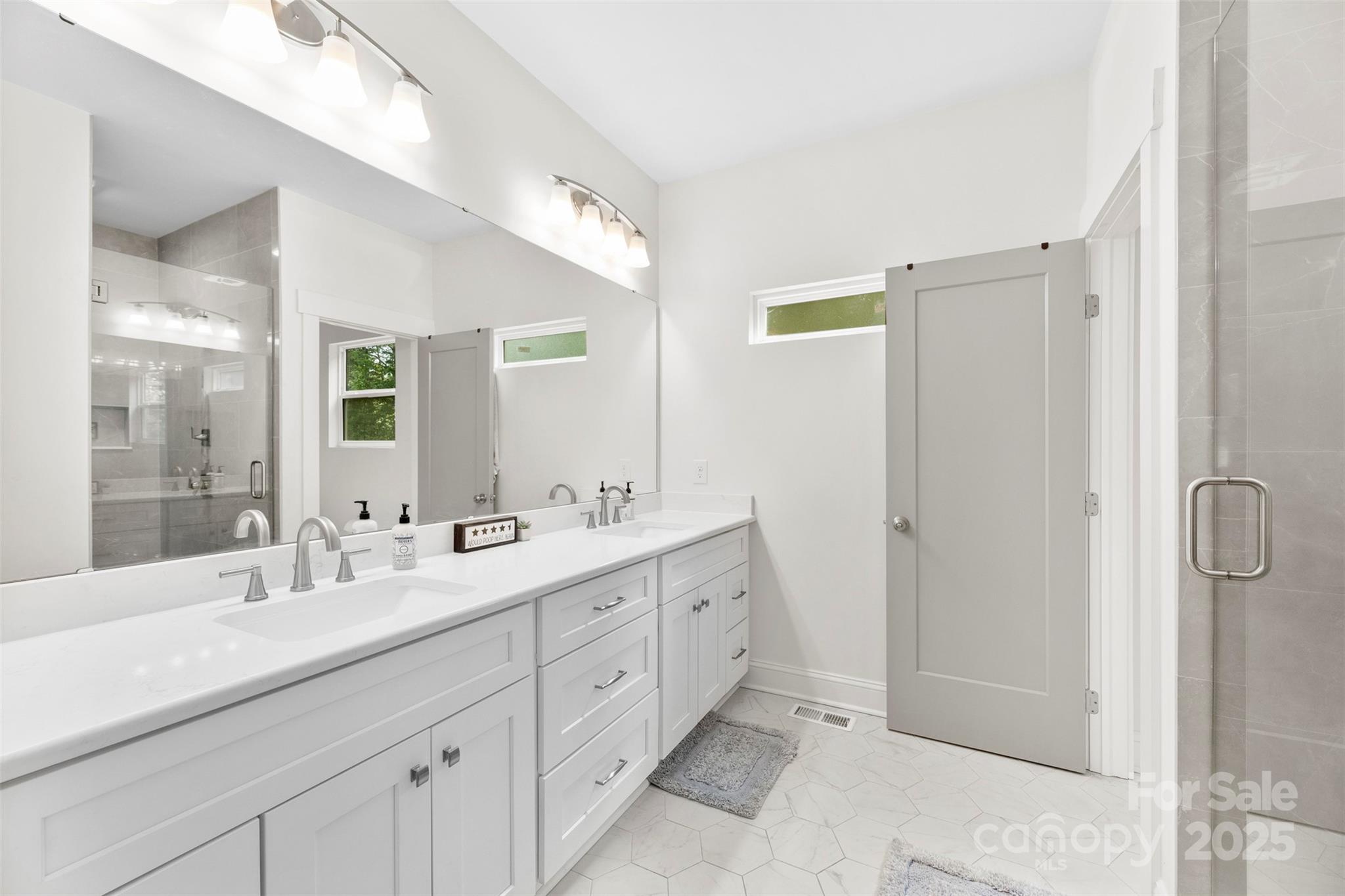 7683 Sarah Drive Denver, NC 28037 - Photo 20 of 25 a bathroom with a double vanity sink mirror and double