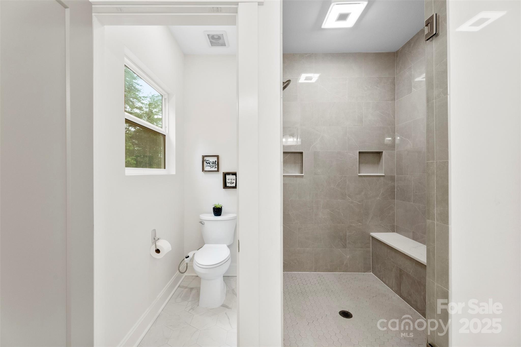 7683 Sarah Drive Denver, NC 28037 - Photo 21 of 25 a bathroom with a granite countertop toilet a sink a mirror and shower