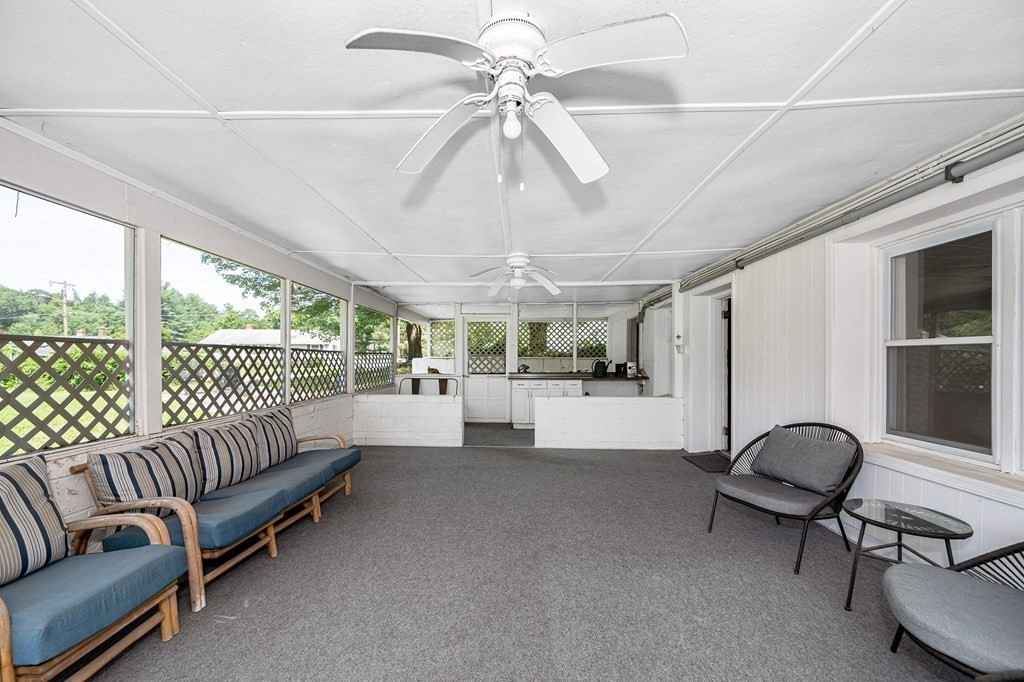 174 Frost Road Tyngsborough, MA 01879 - Photo 12 of 17 a living room with furniture and a chandelier