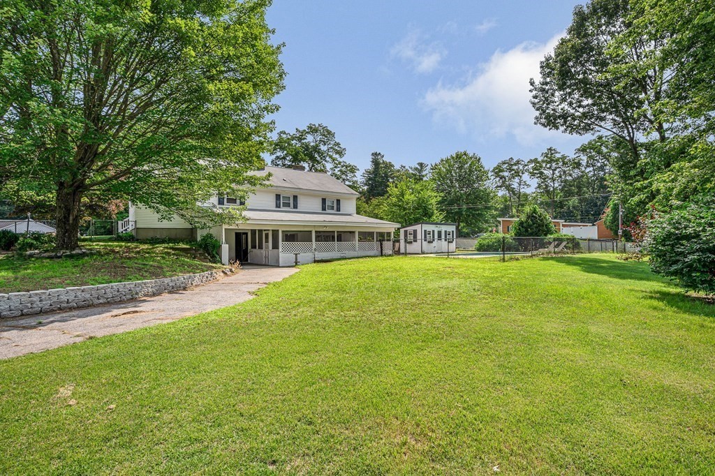 174 Frost Road Tyngsborough, MA 01879 - Photo 15 of 17 a front view of a house with a yard table and chairs