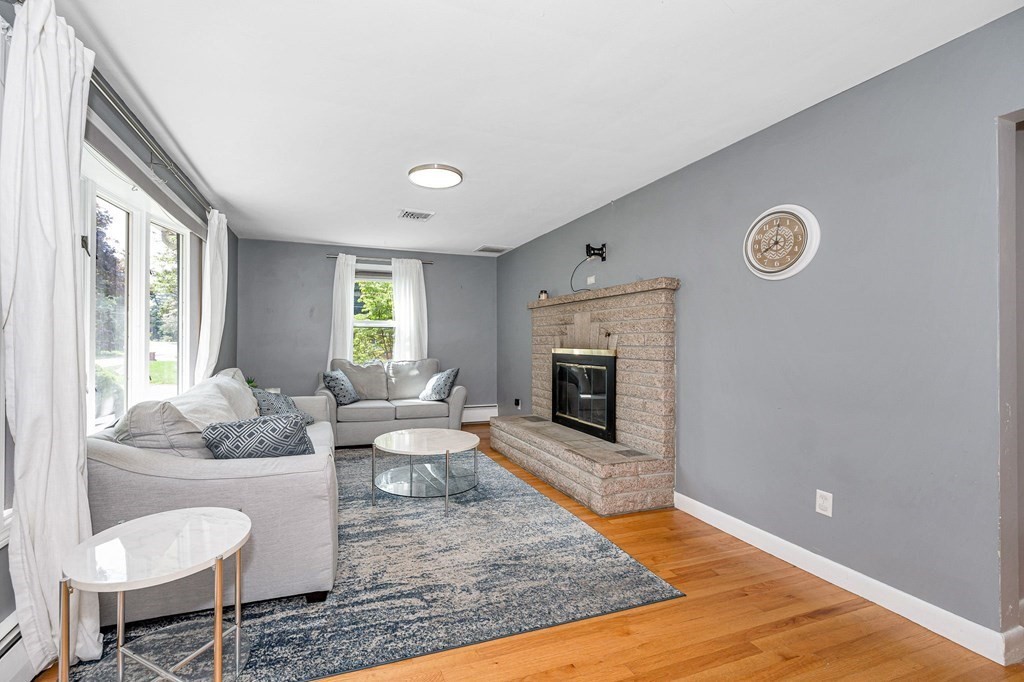 174 Frost Road Tyngsborough, MA 01879 - Photo 2 of 17 a living room with furniture and a fireplace