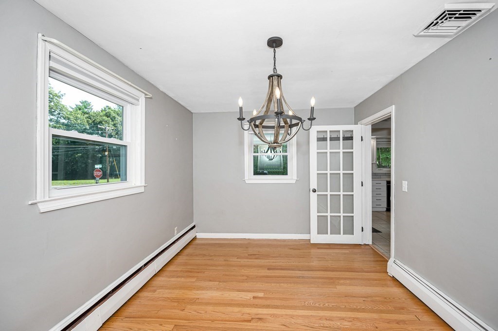 174 Frost Road Tyngsborough, MA 01879 - Photo 4 of 17 a view of empty room with wooden floor and fan