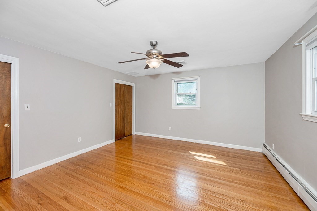 174 Frost Road Tyngsborough, MA 01879 - Photo 6 of 17 an empty room with wooden floor and windows