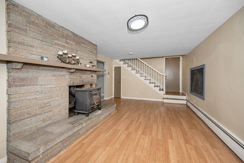 174 Frost Road Tyngsborough, MA 01879 - Photo 9 of 17 a view of a livingroom with wooden floor and staircase