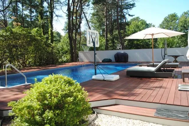 a view of a backyard with chairs and a small yard