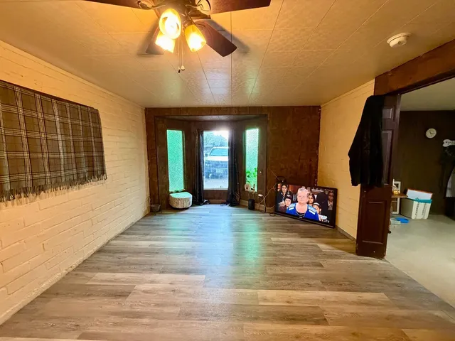 a view of a livingroom with a hall and furniture